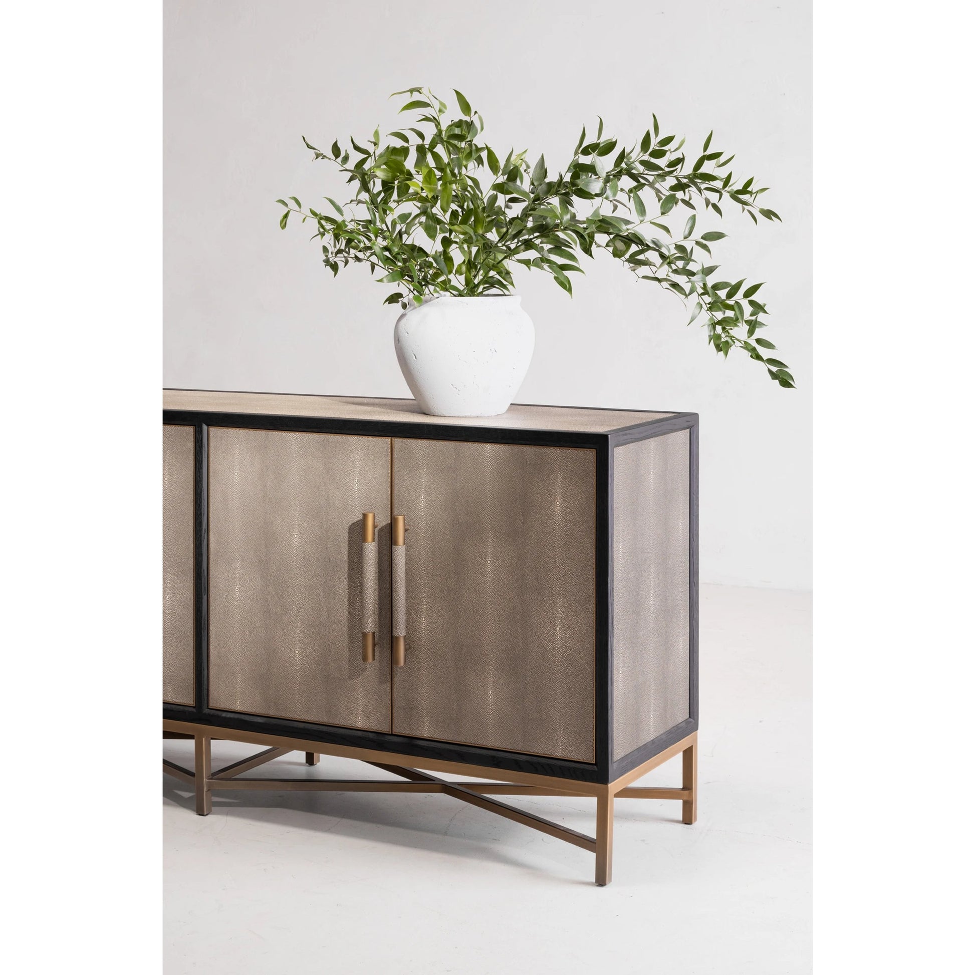 Mako Sideboard by Moe's Home Collection. Made from shagreen patterned polyurethane, solid black oak frame, brass legs, plywood on door, side panel, top panel back panel in a modern style.