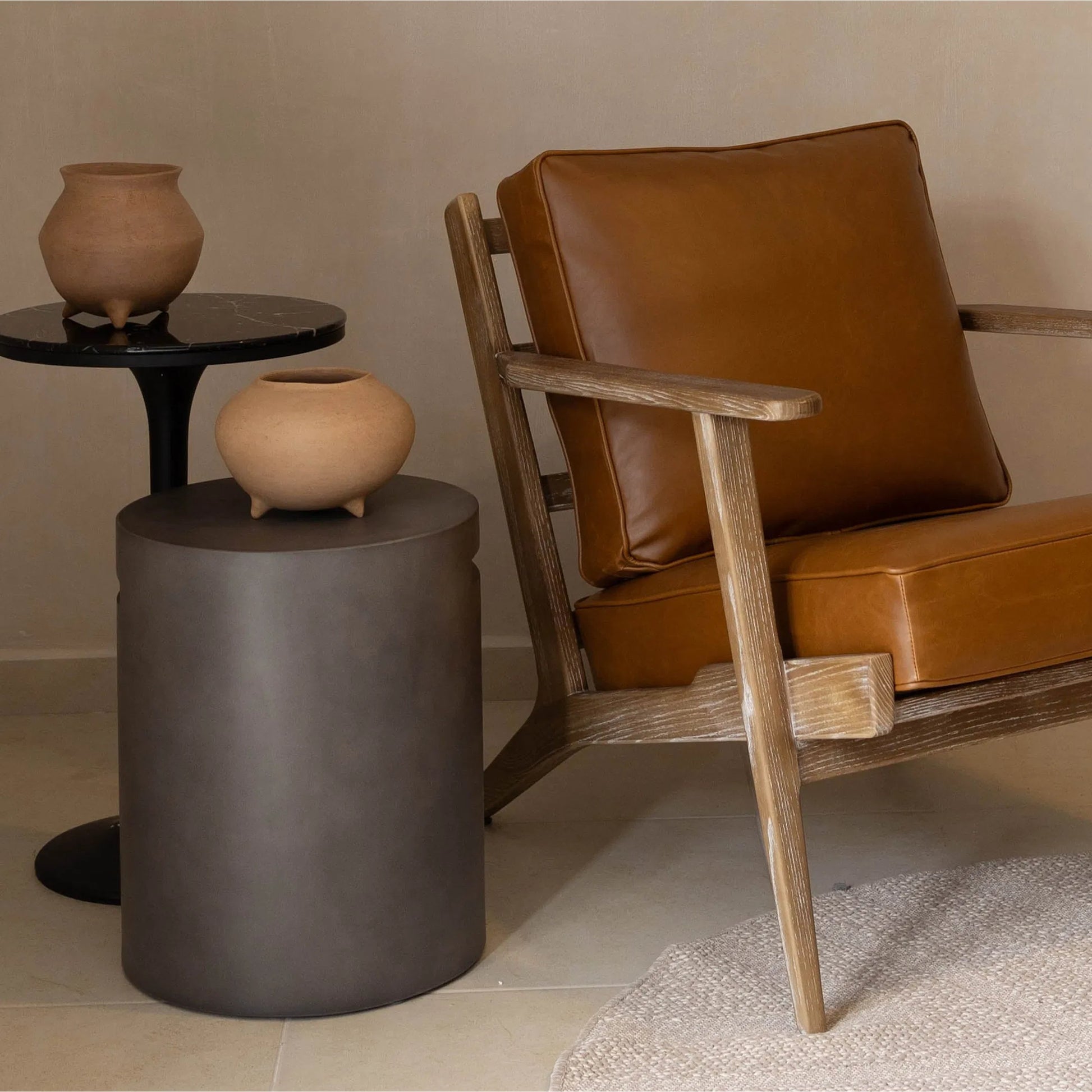 Concrete Round Side Table With Handle by LH Imports in grey. Made from dark grey concrete in a modern style.