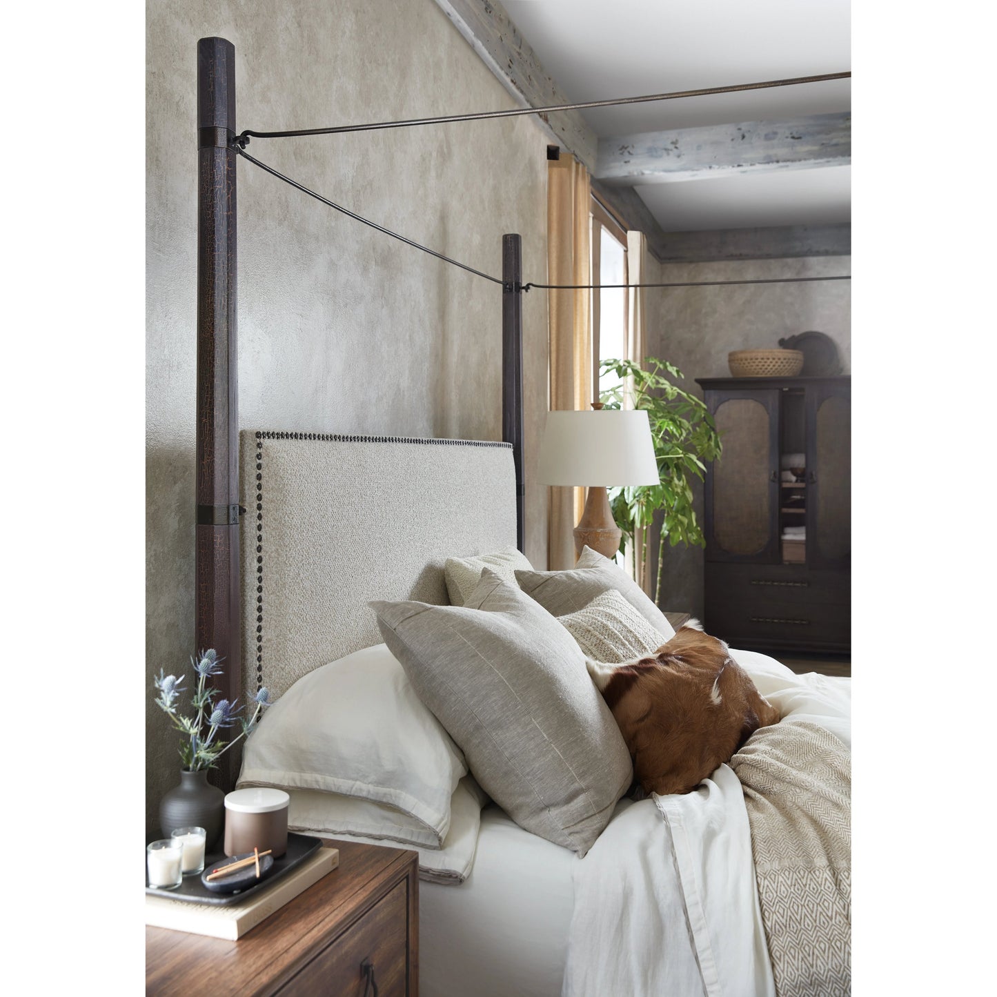003 SI-1959520,SI-1959521 | Lifestyle | Big Sky Poster Bed by Hooker Furniture in beige and charred timber. Made from pecky hickory veneers, fabric, metal, nailheads in a modern style.