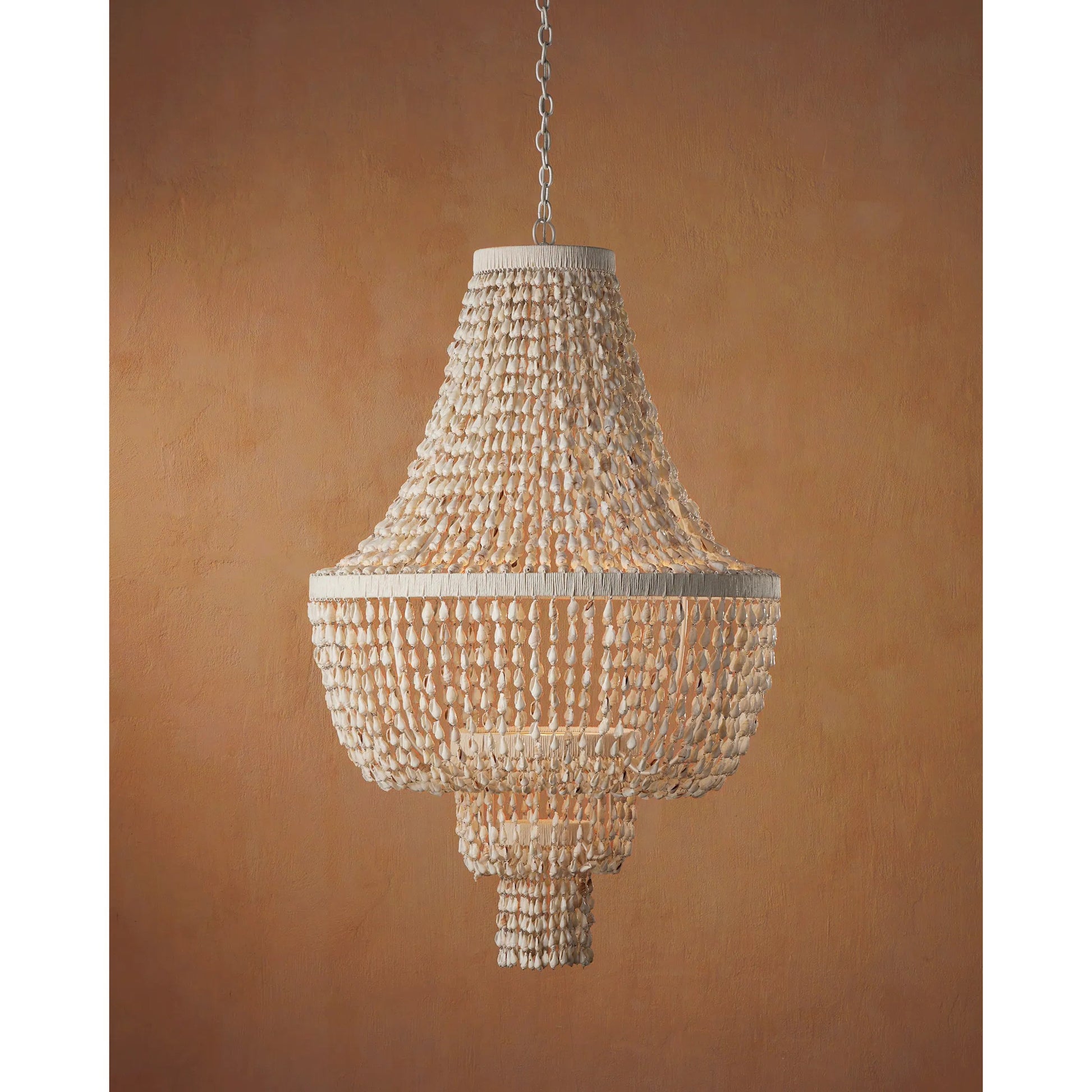 Cybele Chandelier by Currey and Company in natural, pearlized white, white. Made from shells, wrought iron, kraft paper twine in a modern style.
