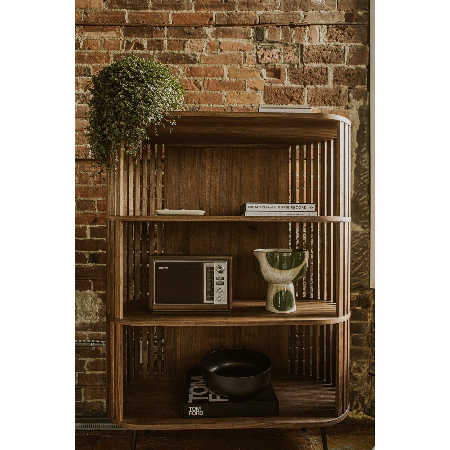 006 SR-866754 | Lifestyle | Henrich Bookshelf by Moe's Home Collection in oil. Made from solid wanut, walnut veneer shelves, steel legs in a modern style.