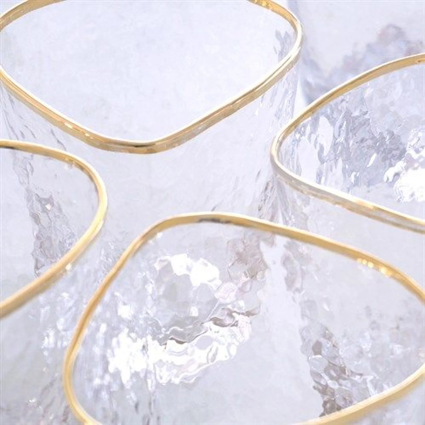002 SR-893011 | Closeup | Hammered Water Glasses by Global Views in clear w, gold rim. Made from glass in a transitional style.