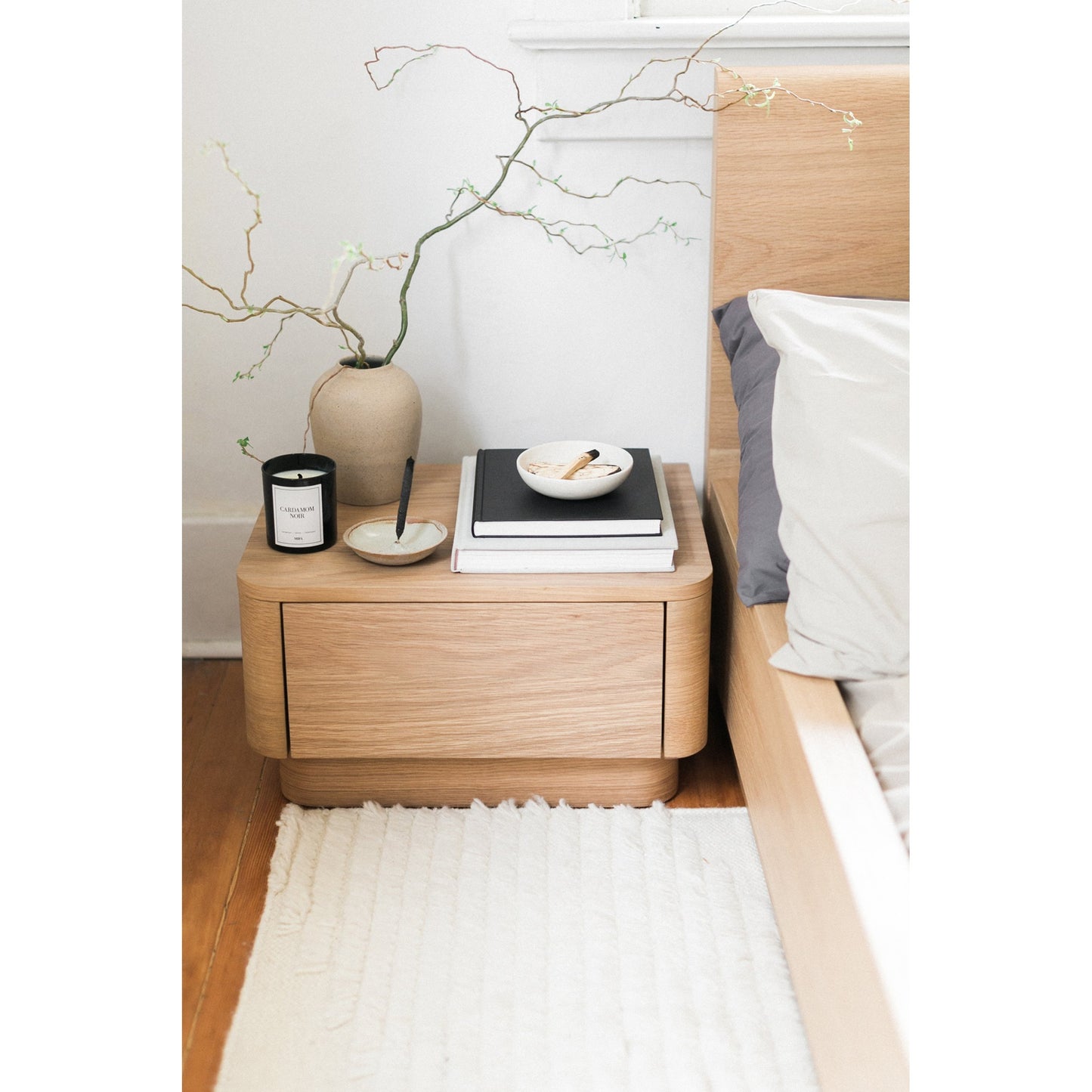 005 SI-1771823 | Lifestyle | Round Off Nightstand by Moe's Home Collection in brown. Made from solid oak, oak veneer, mdf in a transitional style.