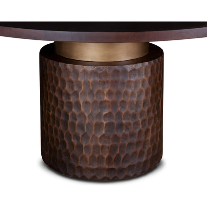 Vallarta Carved Wood Round Dining Table by World Interiors in bronze, gold and two toned bronze. Made from mango wood, cast aluminum in a eclectic & global style.