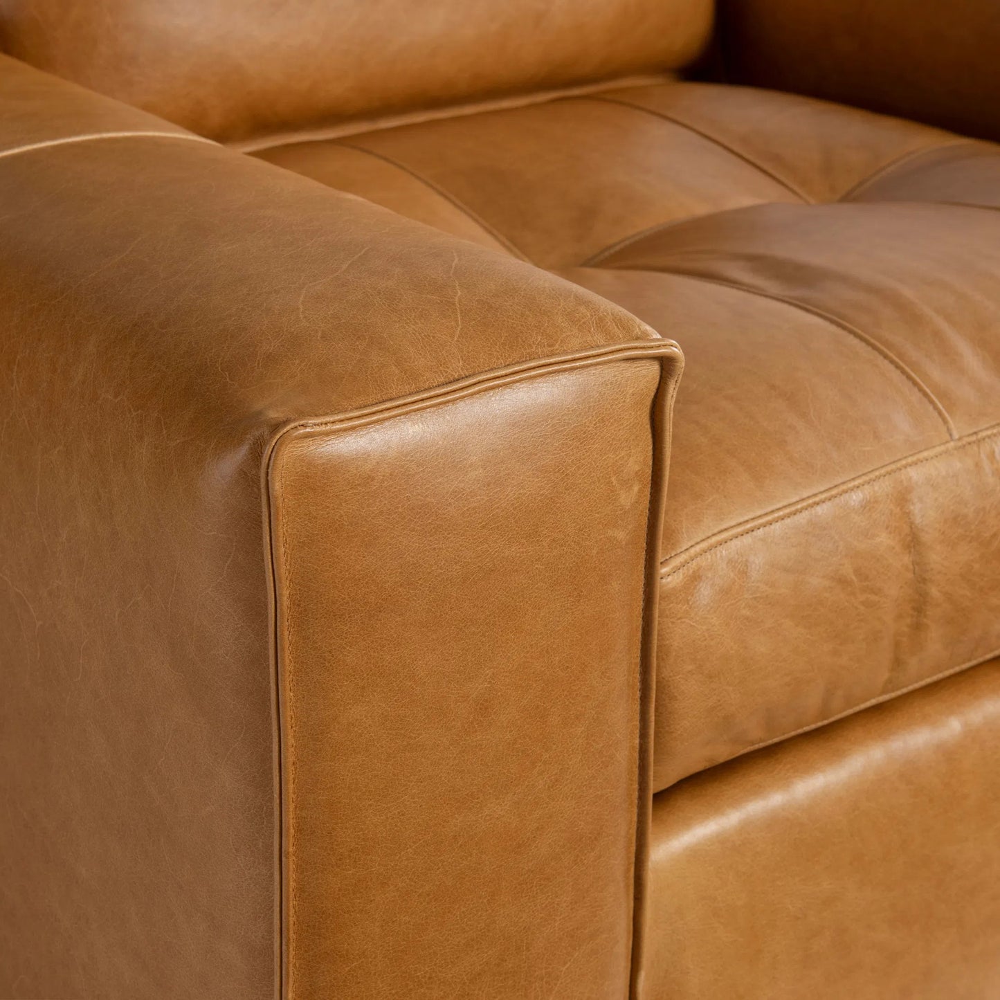 005 SI-2453326 | Closeup | Nest Leather Swivel Chair by Bernhardt in tan. Made from leather, polyfoam core, polyester fibers, waterfowl feathers, waterfowl down in a traditional style.